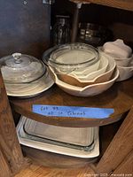 Lazy-Susan shelf with Pyrex mixing bowls, round casserole with lid, additional glass bakeware