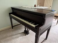 Front and keyboard view of Weber baby grand piano showing pedals and legs