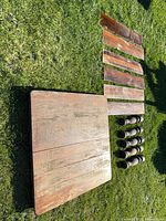 Tabletop, six leaves, and five legs arranged on grass