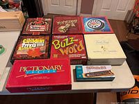Overview of all eight boxed games laid out on table