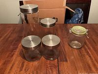 All five storage containers grouped on table