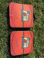 Two Capital One NCAA Final Four seat cushions on grass
