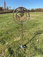 Full view of copper sprinkler staked in lawn