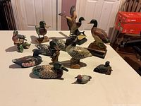 All thirteen duck figures arranged on tabletop