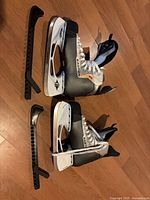 Pair of Easton skates with blade guards side view