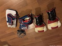 All items laid out: pair of shin pads, catcher glove, blocker, cage mask