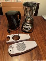 Overview of blender, kettle, and two chopper pieces on table