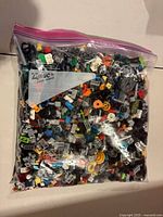Front view of sealed zipper bag filled with assorted LEGO parts