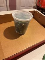 Plastic tub filled with marbles inside a box