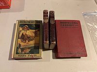 Front view of all four books standing upright