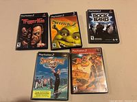 Front view of all five PS2 game cases