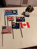 Group shot showing figurine and all six flags