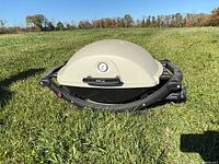 Closed Weber Q grill front view on grass