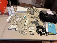 Overall view of Wii console, controllers, cables, charging dock, carry bag and manuals