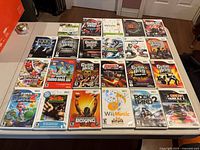 All 23 Wii game cases laid out on table