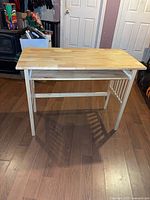 Full view of light wood desk, top and legs visible