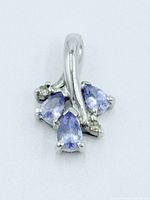 Front view showing three pear-shaped tanzanites and white gold setting