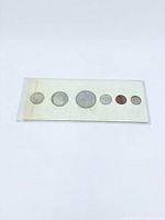 Full view of six coins in original sealed sleeve