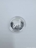 Reverse of 1997 Canadian 50-cent silver coin showing Canadian Coat of Arms, denomination and year