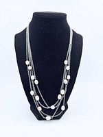 Necklace displayed on bust showing multi-strand design and pearls