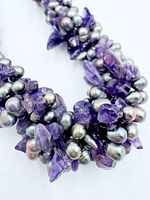 Close-up of amethyst chips and baroque pearls showing materials and color