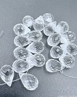 Close-up of clear faceted teardrop beads on string