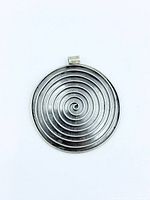 Front view of circular silver pendant showing spiral pattern
