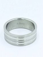 Straight-on view of stainless steel ring showing interior "S. Steel" mark and grooved exterior