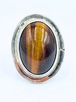 Front view showing oval tiger’s eye stone and silver bezel