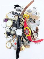 Pile of assorted watch parts, complete wristwatches, bands and measuring tool on white background