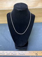 Chain displayed on black bust form