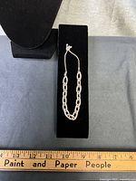 Full view of bracelet on display pad with ruler for scale