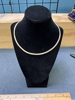 Necklace on bust form showing gold-wash side