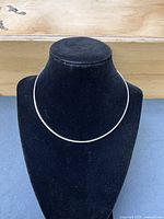 Necklace displayed on bust to show overall form