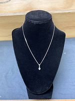 Necklace displayed on bust form