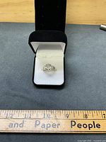 Ring front view in box showing gemstone and setting