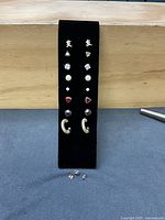 Full view of earring display showing all pairs and spare backs