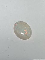 Oval opal cabochon showing play-of-color