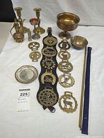 Overall lot layout showing all brass and silver-plated pieces