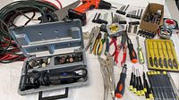 Overview of all tools including drill, Dremel case, pliers, screwdrivers, bits, cable coil
