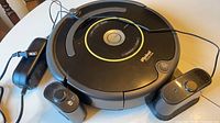 Roomba vacuum with charging dock, power adapter and two virtual wall units