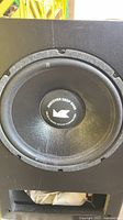 Front view showing woofer with MK logo and port cut-out