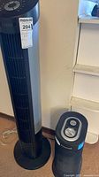 Tower fan and air purifier side by side showing size and cords