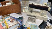Overall lot showing Singer machine, wood caddy, patterns, notions and foot pedal