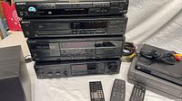 Front view of stacked Sony components, GE VCR, remotes and speaker
