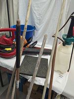 Powered tools, sprayer, stone, rake handles visible