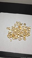 Overview of entire lot of citrine cabochons spread on white background