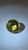 Round lemon citrine gemstone showing face-up view and color