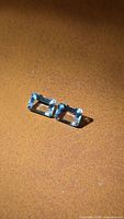 Pair of rectangular aquamarine gemstones on surface
