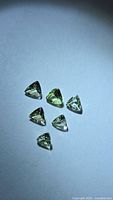 Six trillion cut green tanzanite gemstones on white background